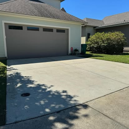 Same residential driveway fully pressure washed by Precision Wash Co., showing uniform clean concrete. Same residential driveway fully pressure washed by Precision Wash Co., showing uniform clean concrete.